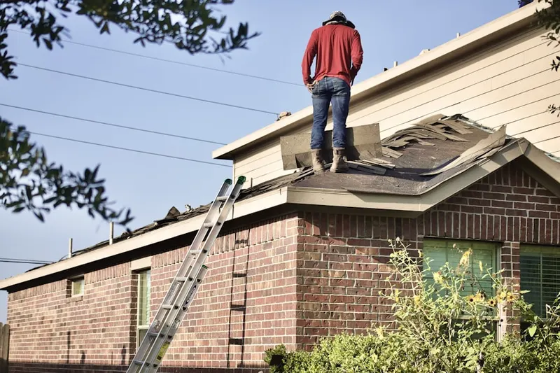 Professional roofer working on a residential roof in Isanti Estates
